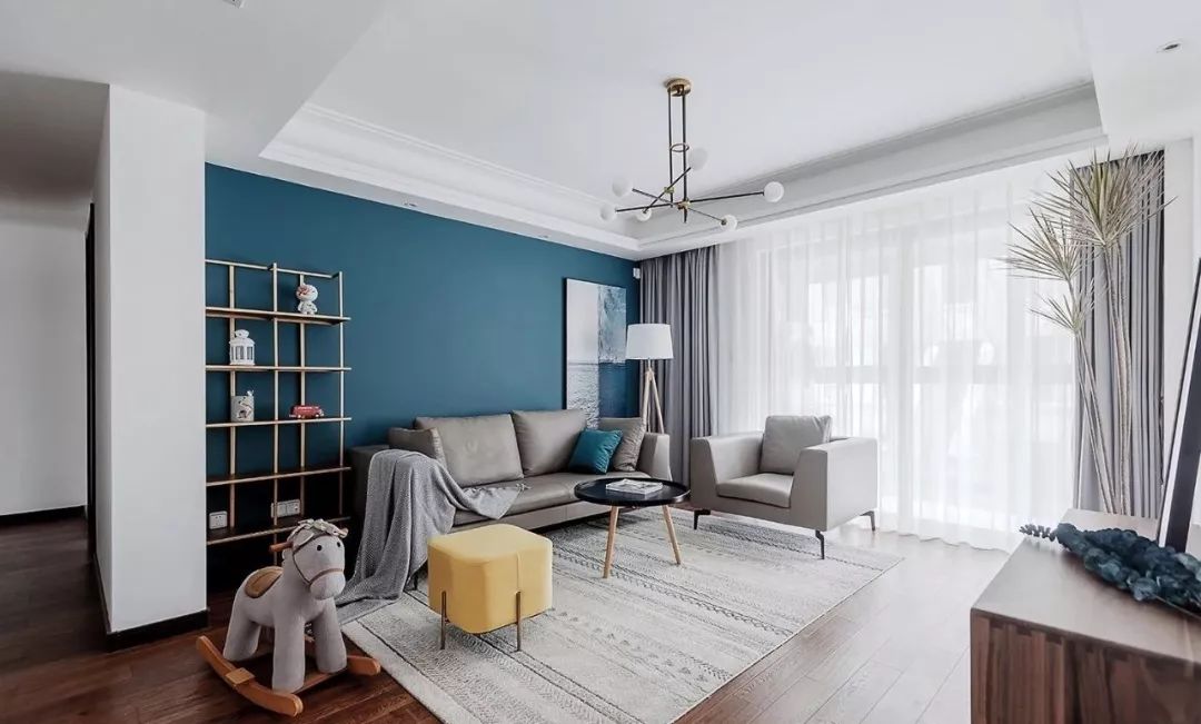 沙发背景墙选择了饱和度低的复古蓝作为空间主基调,为居室营造出沉静